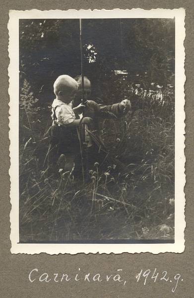 1942 - Carnikava, Latvia<br />Egils gets a fish from father.