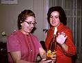 Feb 1964 - At Eriks' and Velta's in Jamaica Plain, Boston, MA.<br />Velta and Helga (Velta's sister Mirdza's daughter) admiring a liquor bottle.
