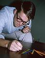 Aug 1964 - At parents' apartment in Ipswich, MA.<br />Uldis playing pick-up sticks.