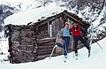 March 4, 1982 - Zermatt, Switzerland.<br />Dave and Oscar in front of a log hut just above Furi.