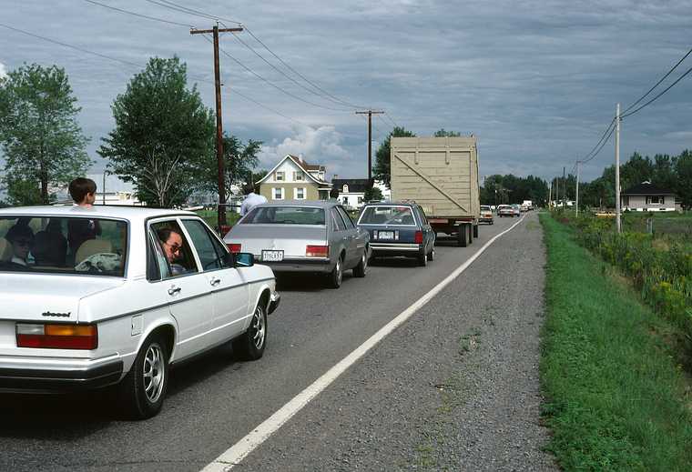 August 12, 1982 - Between Trois Rivieres and Quebec City, Canada.<br />My Audi, with Julian looking out the sunroof and Ronnie out the window,<br />stuck in a traffic jam due to a house being moved.