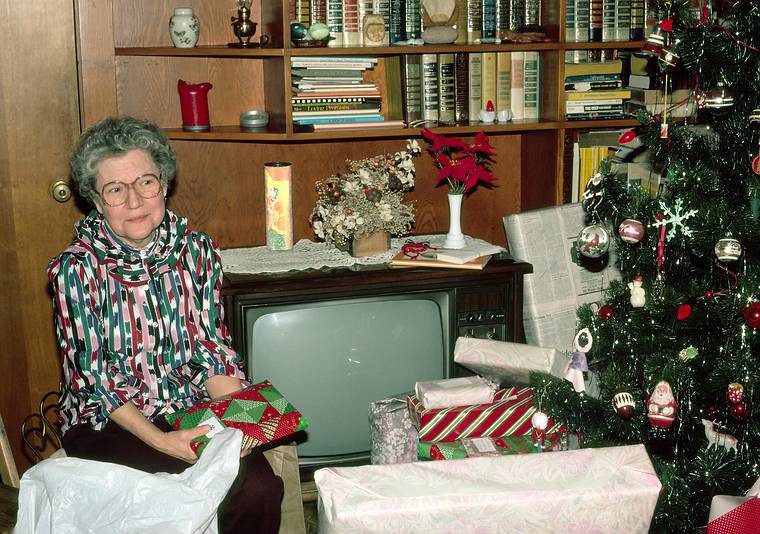 Dec. 25, 1983 - Christmas at Memere Marie's in Lawrence, Massachusetts.<br />Memere Marie doling out the presents.