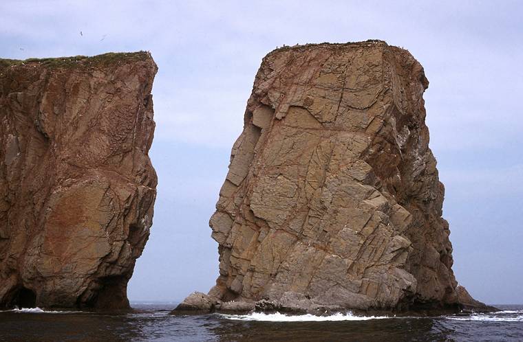 August 4-18, 1985 - Off Perc, Gasp Peninsula, Quebec, Canada.<br />A forillon, a piece of rock that has separated from the mainland.<br />The arch above the opening collapsed sometime at the beginning of the 1900s.