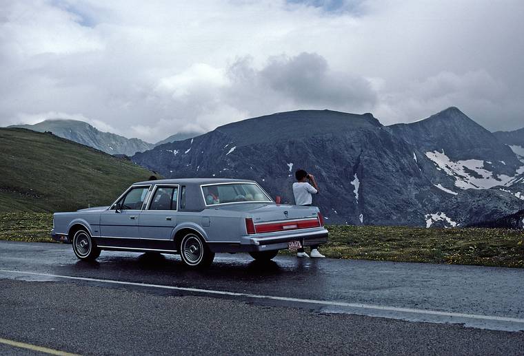 Eric and our rented car, which accomodated all six of us.<br />July 23, 1986 - Rocky Mountain National Park, Colorado.
