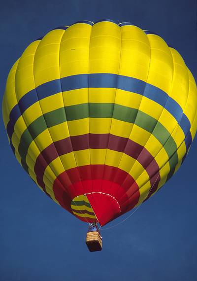 July 25, 1986 - Gunnison, Colorado.<br />Hot air baloon over motel parking lot as we were packing our car.