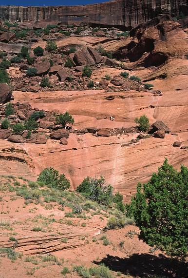 July 31, 1986 - Canyon de Chelly National Monument, Arizona.<br />Canyon wall with Carl, Eric, and Melody way up ahead on the trail.