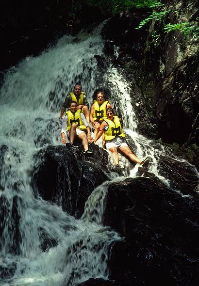 July 13, 1987 - The Forks, Maine.<br />White water rafting on the Kennebeck River with Crabapple.<br />Carl, Tom, Paul, and Norma sitting on a rock in the waterfall.