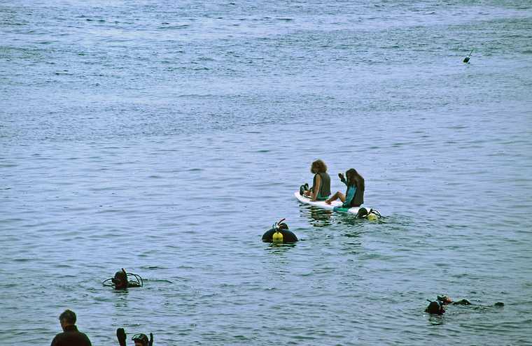 July 2-15, 1988 - Bailey Island, Maine.<br />Becky and Melody paddling on a sailless board among scuba divers.