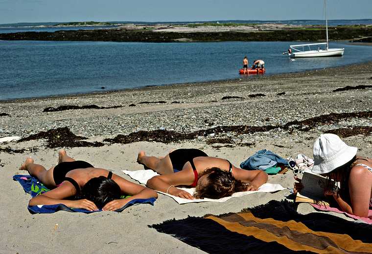 July 2-15, 1988 - Bailey Island, Maine.<br />Melody and Becky sunning themselves while Joyce reads.