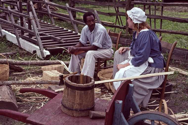 August 20, 1992 - Colonial Williamsburg, Virginia.<br />Basket weaver and a customer.