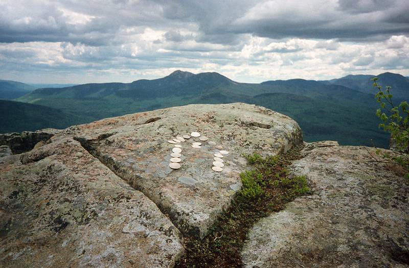 May 27, 1995 - South Moat Mountain, Albany, New Hampshire.<br />The finished work: sand dollar arrow on a rock atop S. Moat and pointing to Mt. Chicoroa.