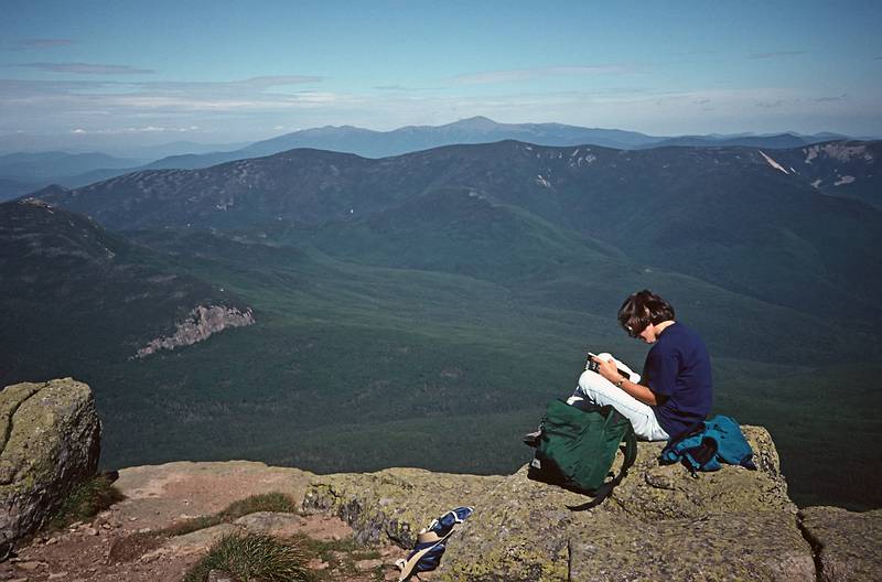 August 26, 1995 - Franconia Notch/Mout Lafayette, New Hampshire.<br />Joyce atop Mount Lafayette with view of Galehead and its ridge nearer and the Presidential Range in the far distance.
