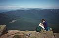 August 26, 1995 - Franconia Notch/Mout Lafayette, New Hampshire.<br />Joyce atop Mount Lafayette with view of Galehead and its ridge nearer and the Presidential Range in the far distance.
