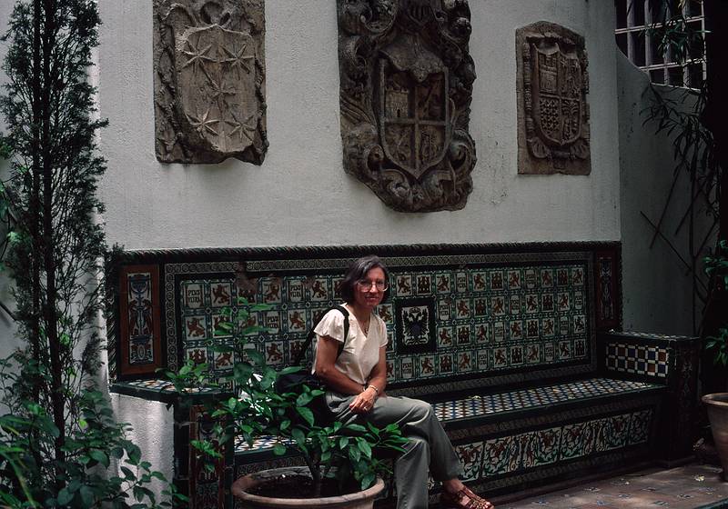 July 7, 1995 - Madrid, Spain.<br />Joyce sitting on a tile bench below coats of arm at the Sorolla Museum yard.