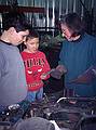 Joyce showing TJ and Michael a piece of a work in progress.<br />At the welding shop where Joyce does her work.<br />Dec. 26, 1998 - Merrimac, Massachuetts.