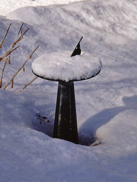 Sundial in back yard, after a snowfall.<br />Feb. 17, 2001 - Merrimac, Massachusetts.