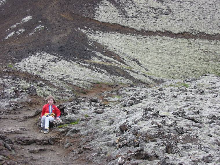 Aug 28, 2001 - Site of an extinct volcano at Grbrk, Iceland.<br />Dagbjrt siting by the side of the trail among moss and lichen covered rocks.