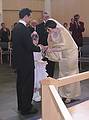 Aug 31, 2001 - Inga and Eric's wedding, Eskifjrur, Iceland.<br />Dagbjrt handing the rings to Eric and Inga, Atli watches, and Haldr photographs.