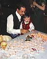 Aug 31, 2001 - Inga and Eric's wedding reception and Atli's 60th birthday celebration, Eskifjrur, Iceland.<br />Gujn, in Eric's lap, admiring all the lit candles in front of them.
