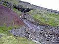 Sept 1, 2001 - Eskifjrur, Iceland.<br />Hillside with stream across valley from town where a mudslide uncovered some peculiarly round rocks.