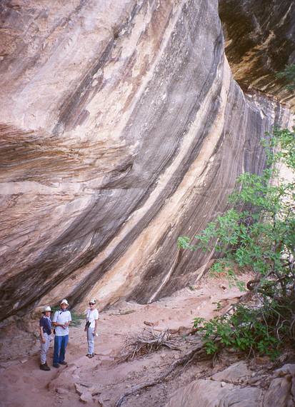 May 16, 2001 - Natural Bridges National Monument, Utah.<br />Joyce, Ronnie, and Baiba on trail under overhanging rock to Sipapu Bridge.