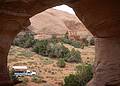 May 17, 2001 - Full day tour of Mystery Valley and Monument Valley, Utah/Arizona.<br />Looking through an arch at our Goulding's Tours truck.