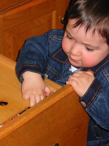 April 29, 2002 - Merrimac, Massachusetts.<br />Gujn opening the bread drawer in the kitchen.