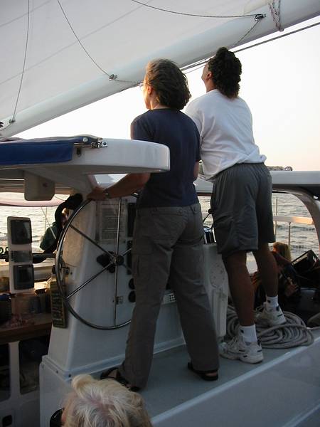 June 21, 2002 - Catamaran evening cruise on the Merrimack River, Newburyport, Massachusetts.<br />Joyce at the helm under the direction of the captain..