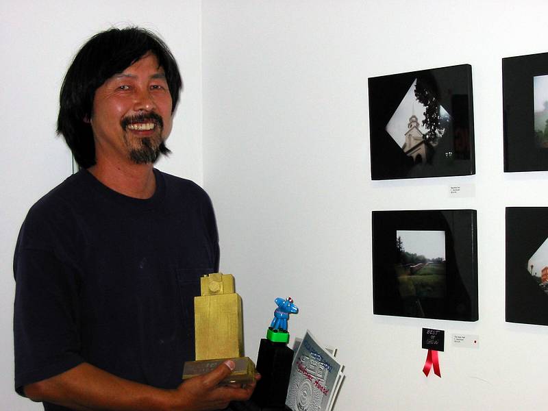 June 28, 2002 - 77 Elm Street, Amesbury, Massachusetts.<br />Mochi and his Best of Show trophy in front of his photos.