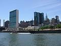 July 5, 2002 - New York, New York.<br />Tug boat pulling a barge in front of the United Nations Headquarters.