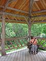 July 15, 2002 - Adirondack Museum, Blue Mountain Lake, New York.<br />Joyce sitting in an Adirondack chair in an Adirondack gazebo.
