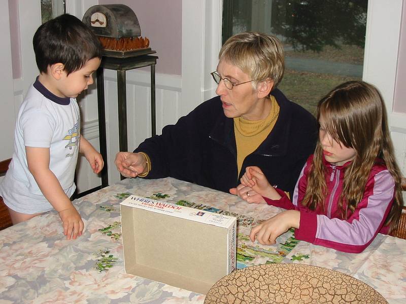 Dec 24, 2002 - Merrimac, Massachusetts.<br />Gujn, Benna, and Dagbjrt doing a jigsaw puzzle at the dining room table.