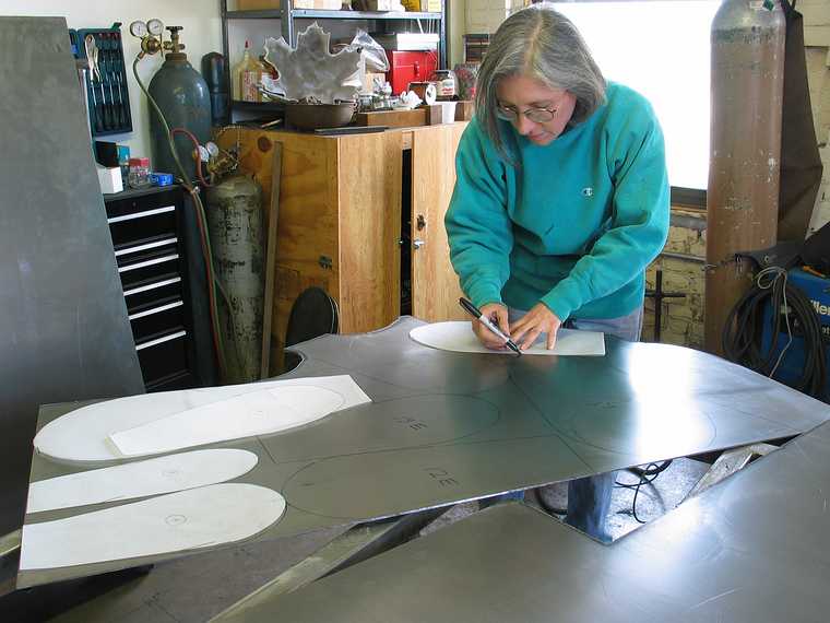 March 4, 2003 - Joyce's studio in Amesbury, Massachusetts.<br />Chicago's Navy Pier Project.<br />Joyce cutting one of 75 white pine cone scales.
