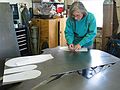 March 4, 2003 - Joyce's studio in Amesbury, Massachusetts.<br />Chicago's Navy Pier Project.<br />Joyce cutting one of 75 white pine cone scales.