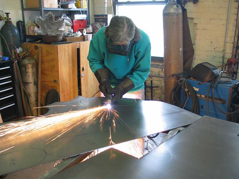 March 4, 2003 - Joyce's studio in Amesbury, Massachusetts.<br />Chicago's Navy Pier Project.<br />Joyce cutting one of 75 white pine cone scales.