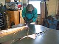 March 4, 2003 - Joyce's studio in Amesbury, Massachusetts.<br />Chicago's Navy Pier Project.<br />Joyce cutting one of 75 white pine cone scales.