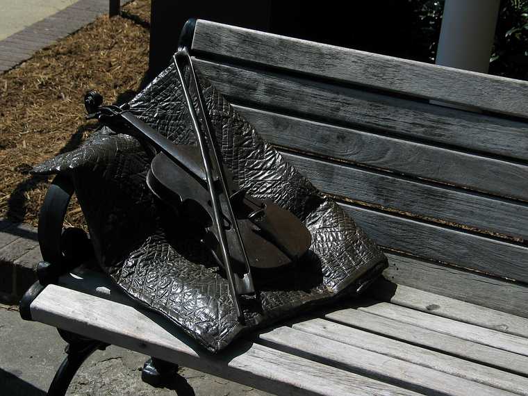 June 21, 2003 - Asheville, North Carolina.<br />On the Guilded Age trail: Appalachian Stage. Quilt and fiddle on bench and five dancers<br />and musicians mark the significance of Appalachian culture on the community.