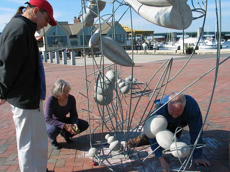 Oct 10, 2003 - Newburyport, Massachusetts.<br />William Brayton installing his sculpture at Somerby's Landing.<br />His helper and Joyce watching.