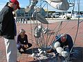 Oct 10, 2003 - Newburyport, Massachusetts.<br />William Brayton installing his sculpture at Somerby's Landing.<br />His helper and Joyce watching.