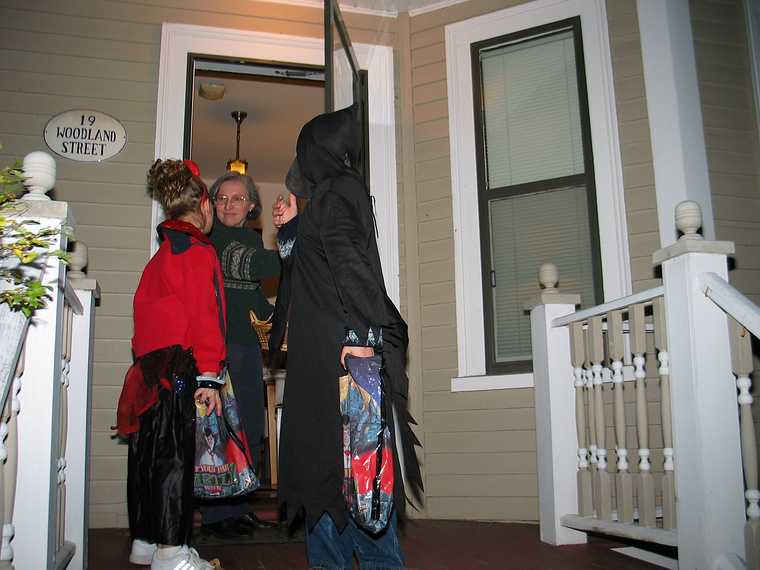 Oct 31, 2003 - Halloween, Merrimac, Massachusetts.<br />Joyce greeting two trick and treaters.