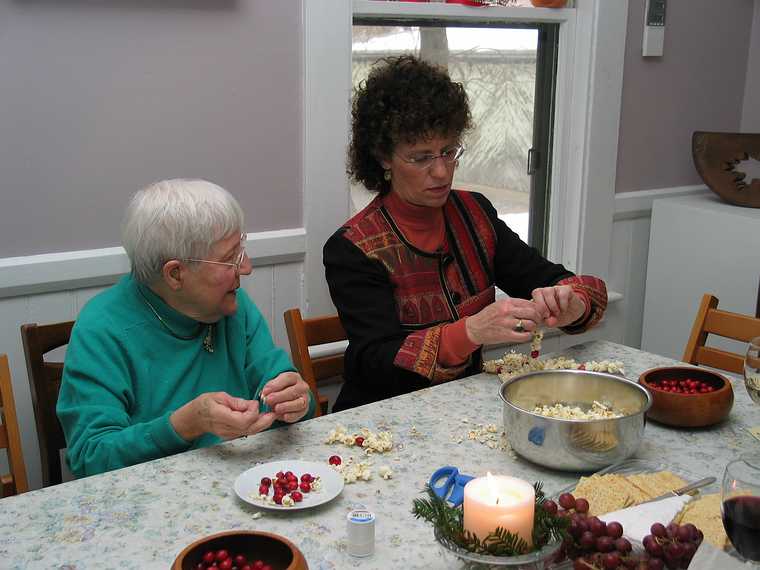 Dec 21, 2003 - Merrimac, Massachusetts.<br />Christmas tree decorating party.<br />Marie and Bonnie  threading cranberries and popcorn.