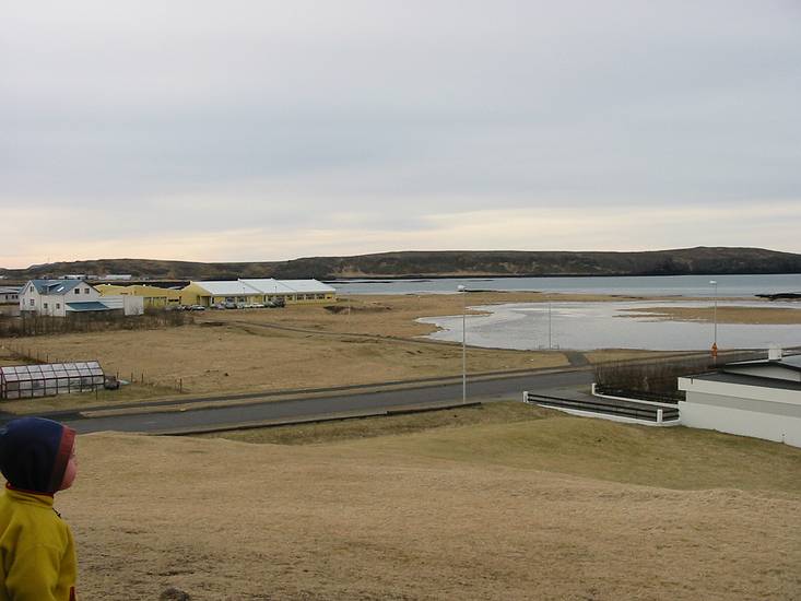 March 23, 2004 - Vogar, Iceland.<br />The large yellow building in the distance is the school where Inga teaches and Dagbjrt attends.<br />In the far distance, at the foot of the hills, the white buildings are an abalone farm.