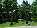 May 25, 2004 - Grounds for Sculpture, Hamilton, New Jersey.<br />Robert Ressler, "Baruch Ashem", 1989.<br />There is a live cardinal perched on the cross piece, 2nd from the left.