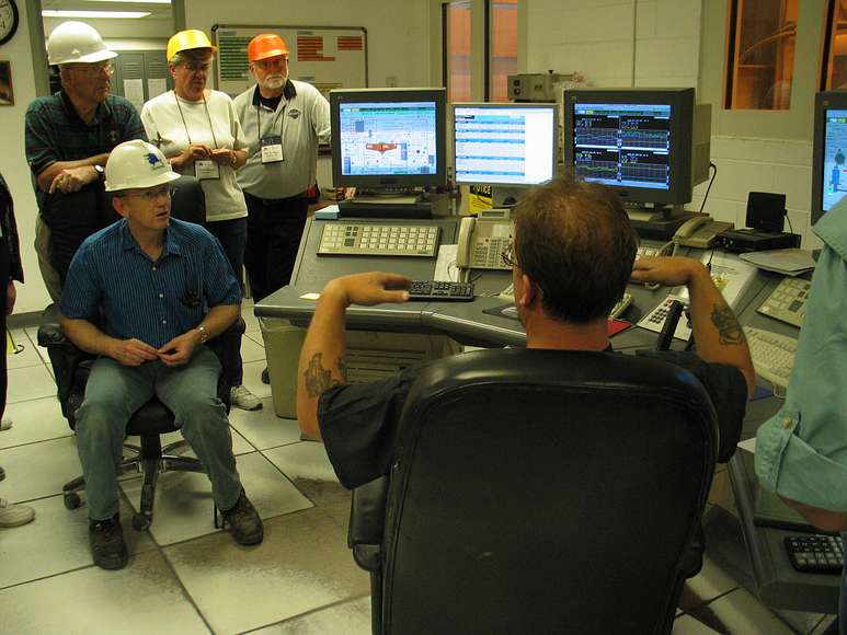 June 18, 2004 - Fort Knox Gold Mine near Fairbanks, Alaska.<br />Arn, Carol, Bill, and our Fort Know tour guide listening to the control room operator.