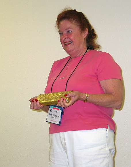 June 18, 2004 - Fort Knox Gold Mine near Fairbanks, Alaska.<br />Pam Johnson being photographed with a 21 lb. bar of gold worth more than $100,000.