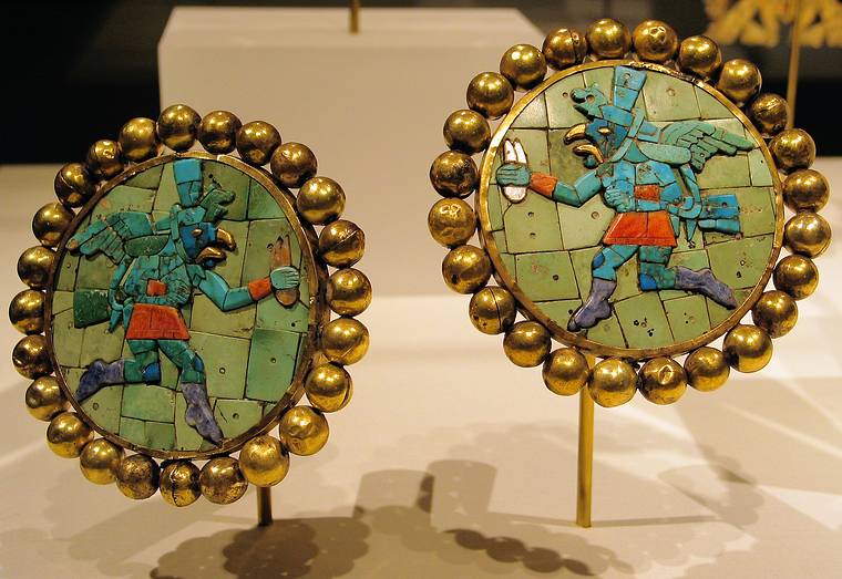 Feb. 12, 2005 - Metropolitan Museum of Art, New York City.<br />Pair of earflares from Peru from the 3rd-7th century.<br />Hammered gold, turquoise, sodalite, and shell inlay.