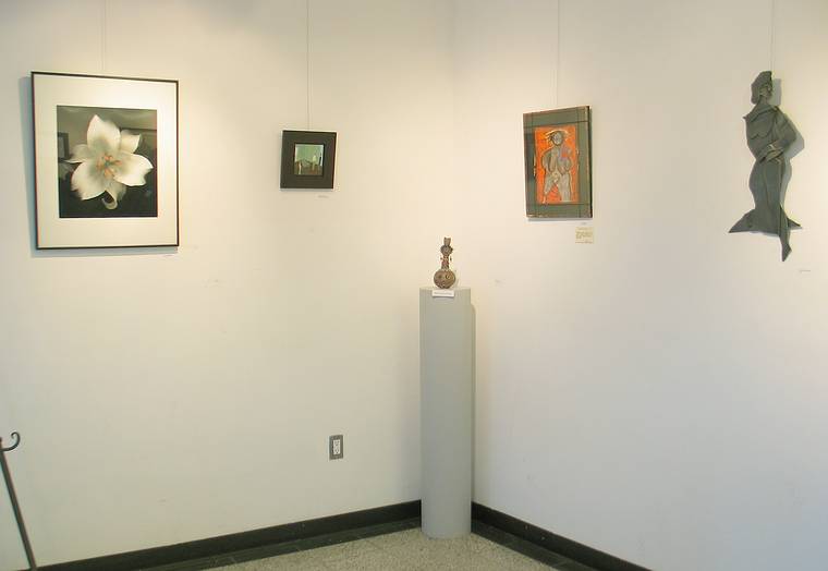 Feb. 20, 2005 - Newburyport, Massachusetts.<br />Harold Feinstein's photograph on the left and Joyce's sculpture on the right<br />at the opening of the Women's Crisis Center fundraiser at the Firehouse.