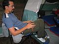 June 16, 2005 - White Lake State Park, Tamworth, New Hampshire.<br />Eric pumping up his air mattresses.<br />This photo was taken through the netting.