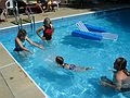 July 4, 2005 - Lawrence, Massachusetts.<br />Celebrating the 4th at Memere Marie's pool.<br />Miranda swimming between Carl and Holly while Joyce watches.