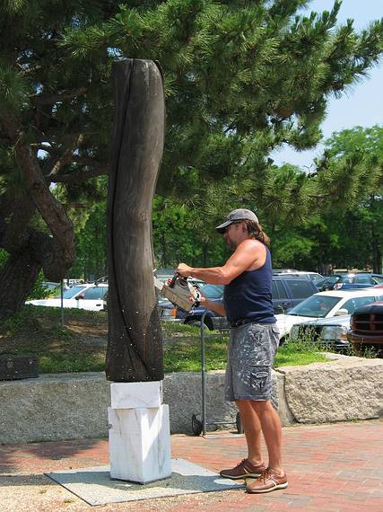 July 13, 2005 - Somerby's Landing, Newburyport, Massachusetts.<br />Richard Aliberti taking a chainsaw to his sculpture to uninstall it.